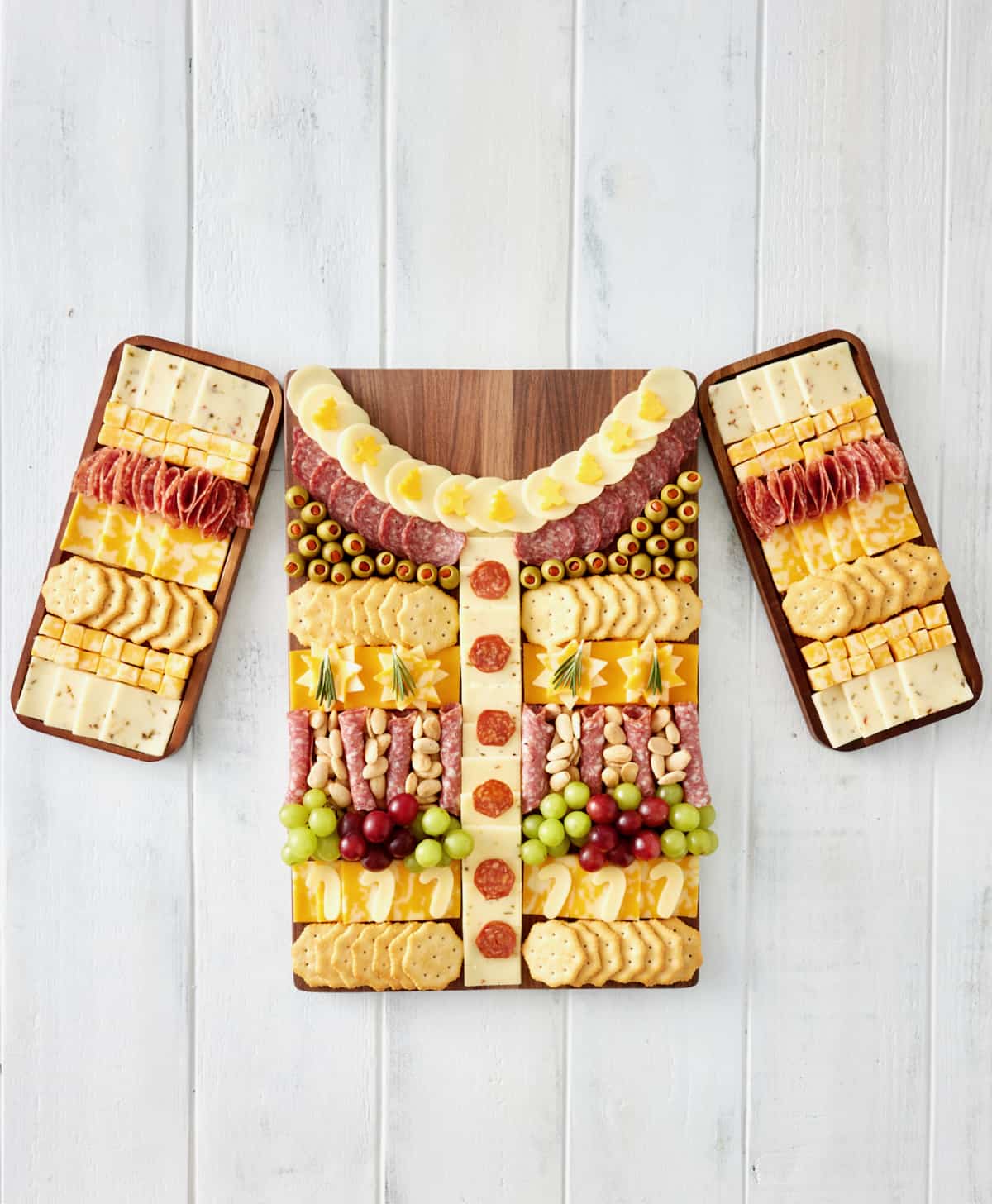 Wooden food boards made to look like an ugly Holiday sweater.