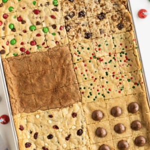 Six kinds of holiday cookies baked into one cookie sheet sitting on a white counter top.