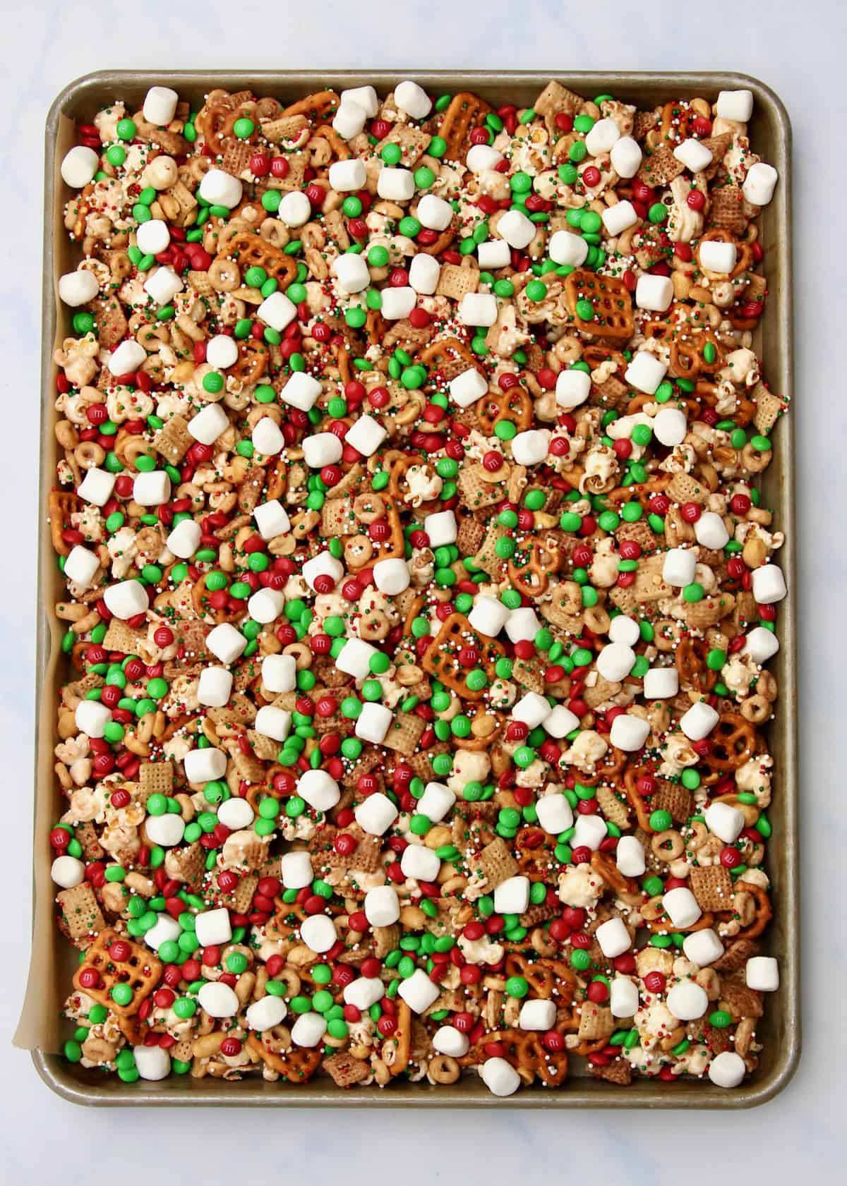A baking tray filled with cooling snack mix.