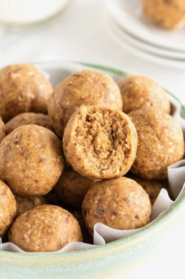 Snack bites in a large pale blue earthenware serving bowl on a white marble counter.