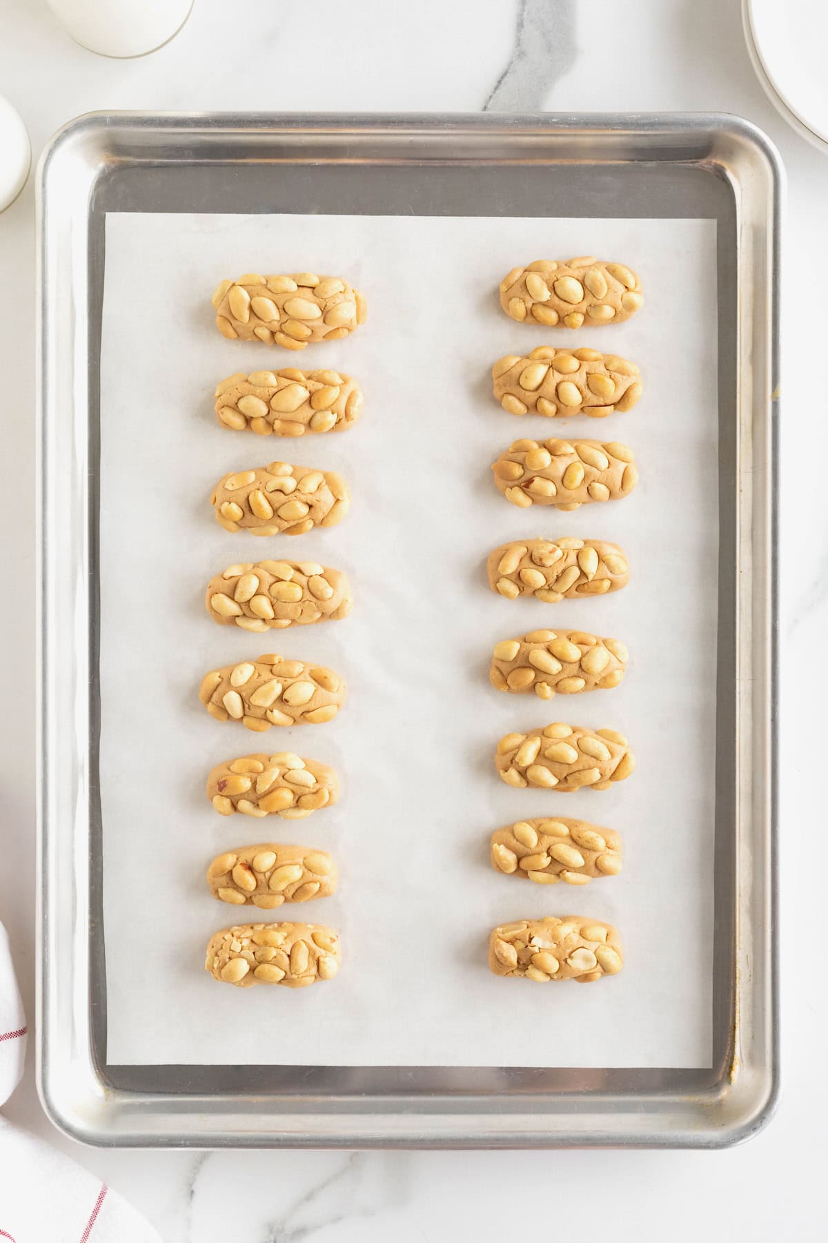 16 miniature payday candy bars on a parchment lined surface.