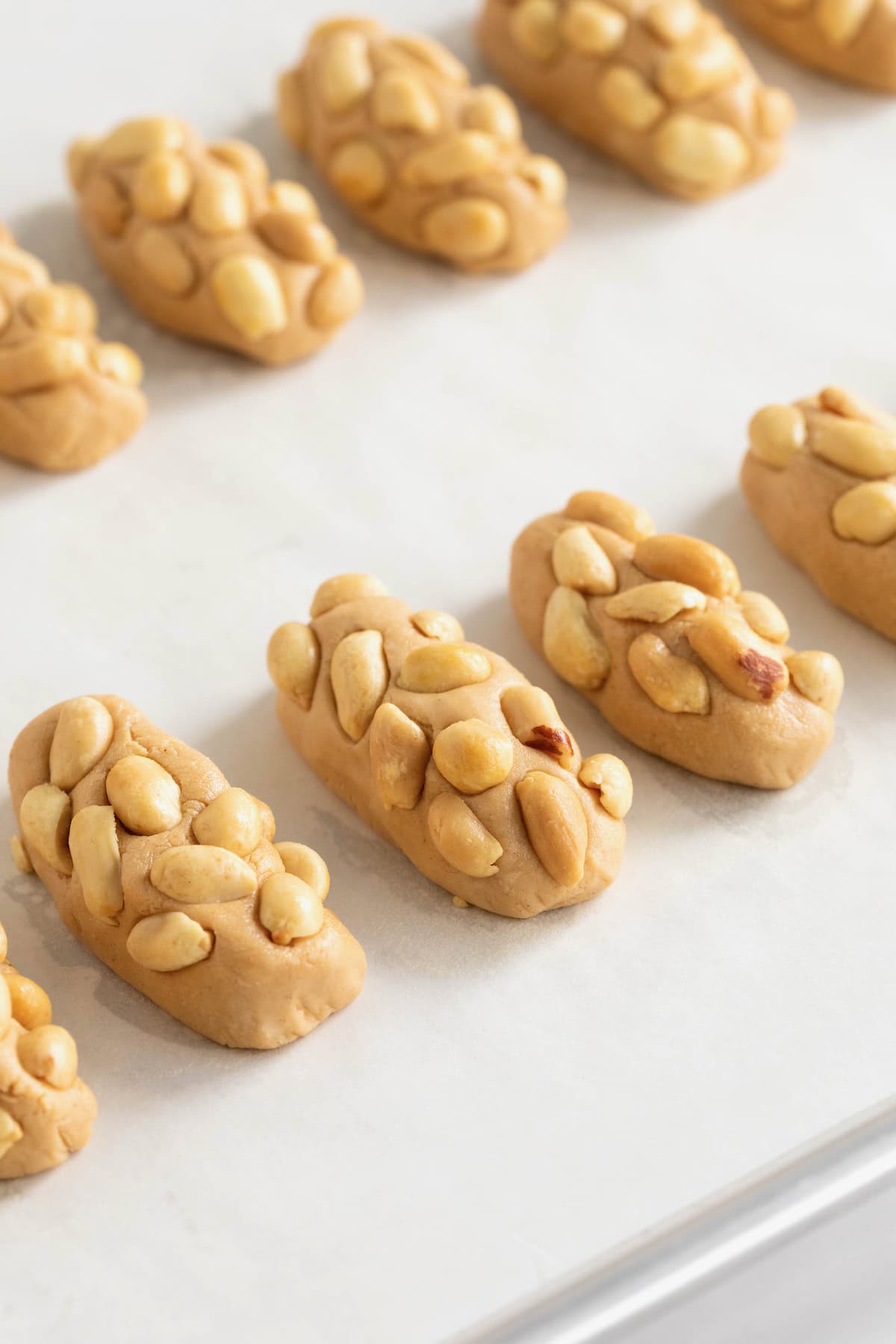 10 miniature payday candy bars on a parchment lined surface.