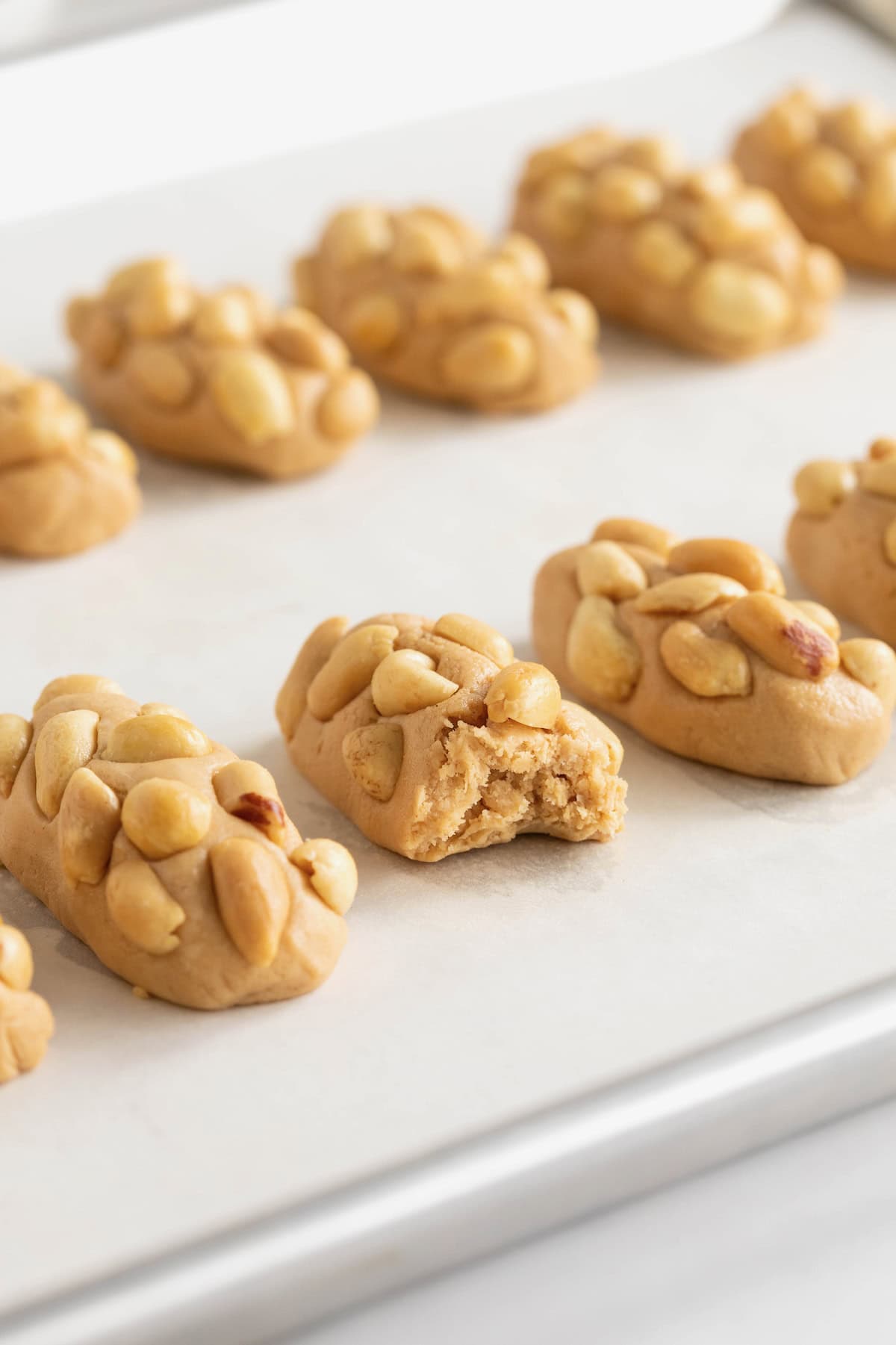 10 miniature payday candy bars on a parchment lined surface.