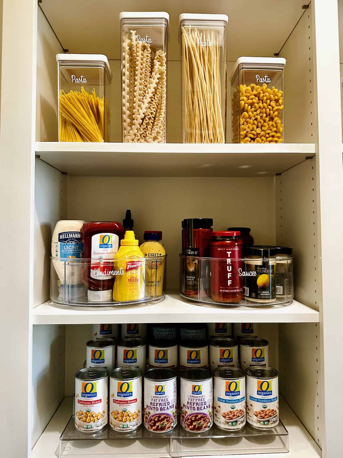 A pantry section with cans and pasta.