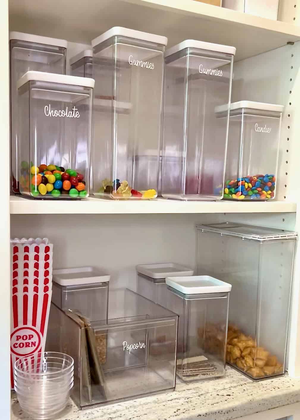 Empty clear containers in a pantry.