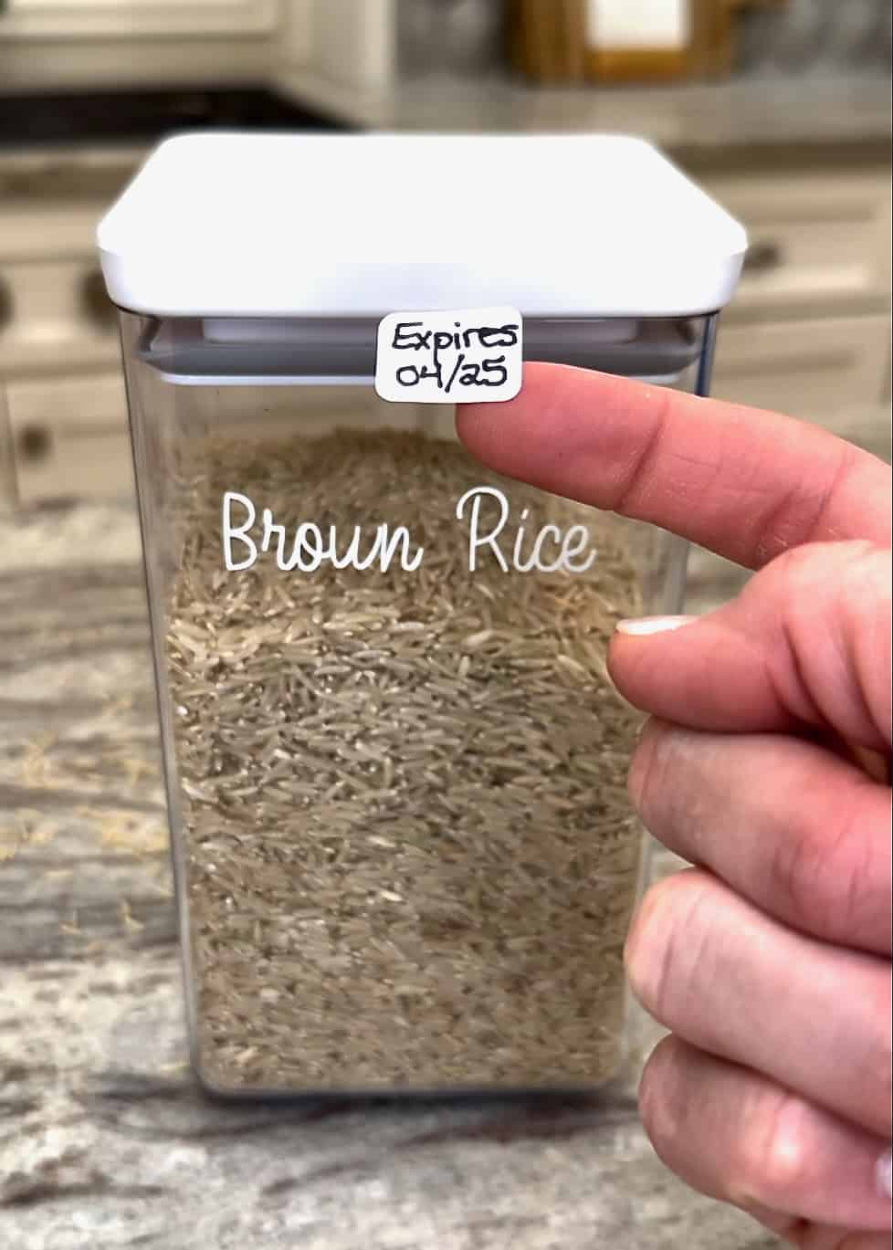 A label being placed and a canister of brown rice.