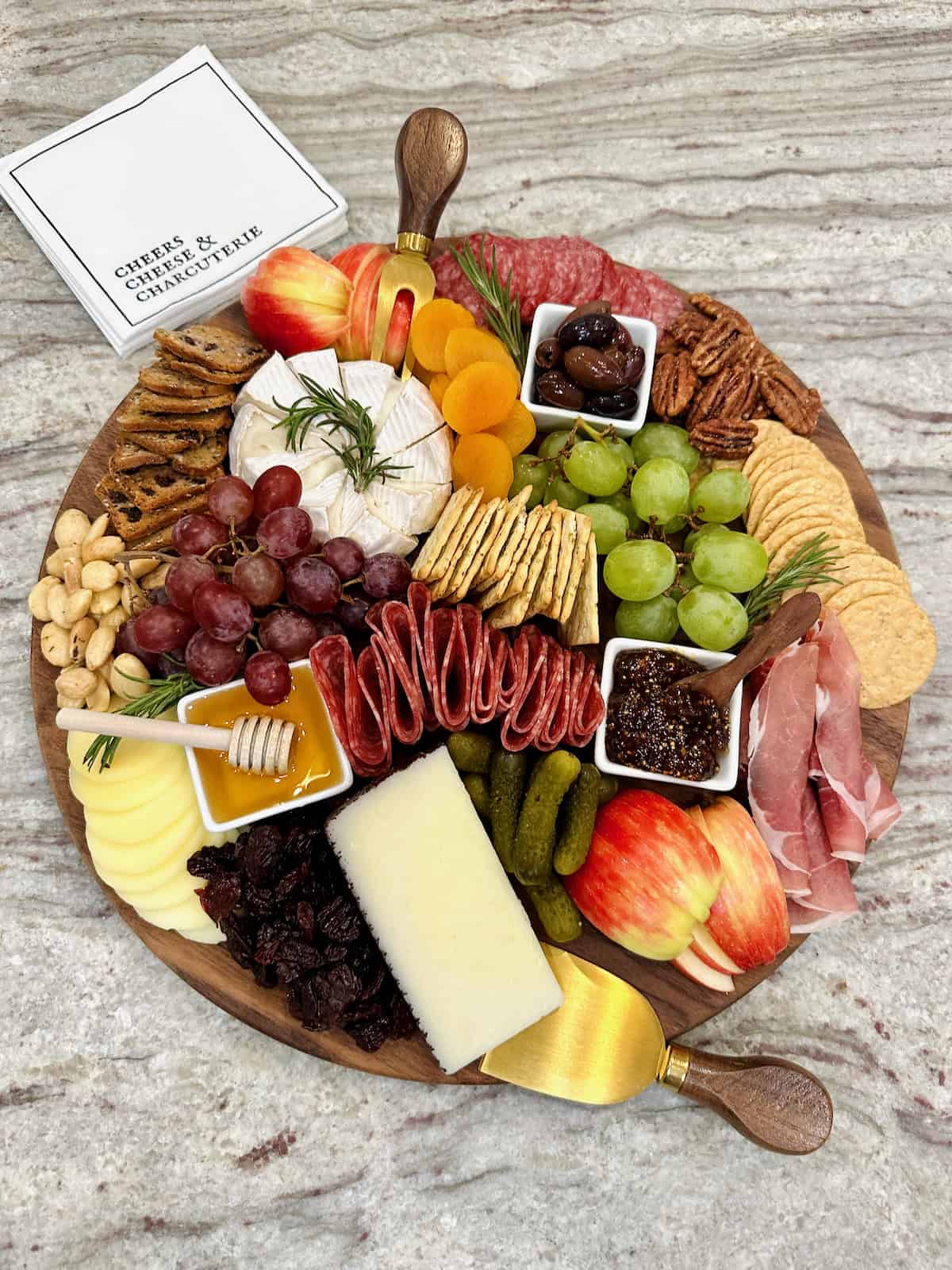 A charcuterie board on a gray marble counter.