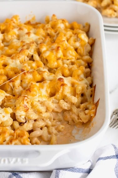 A white ceramic casserole dish of baked macaroni and cheese.