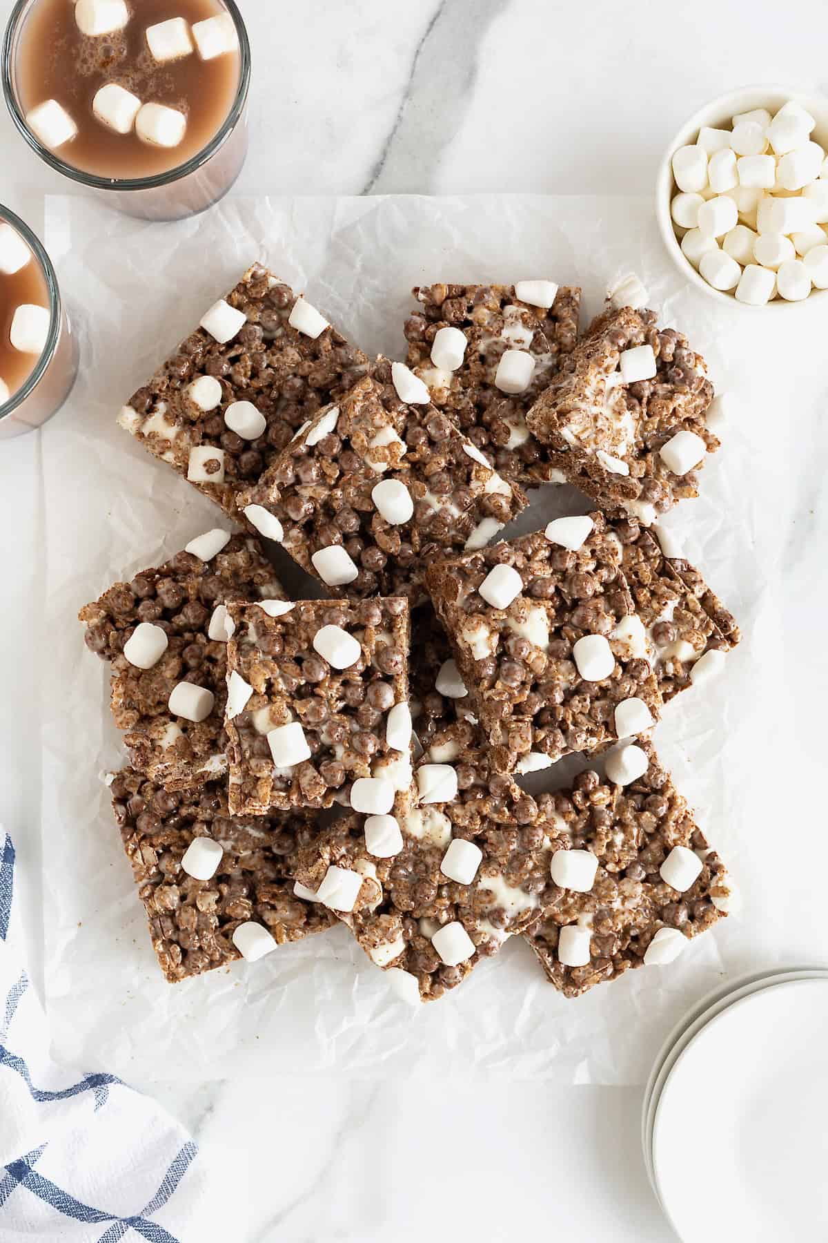 A pile of hot cocoa Krispies treats on a piece of parchment.