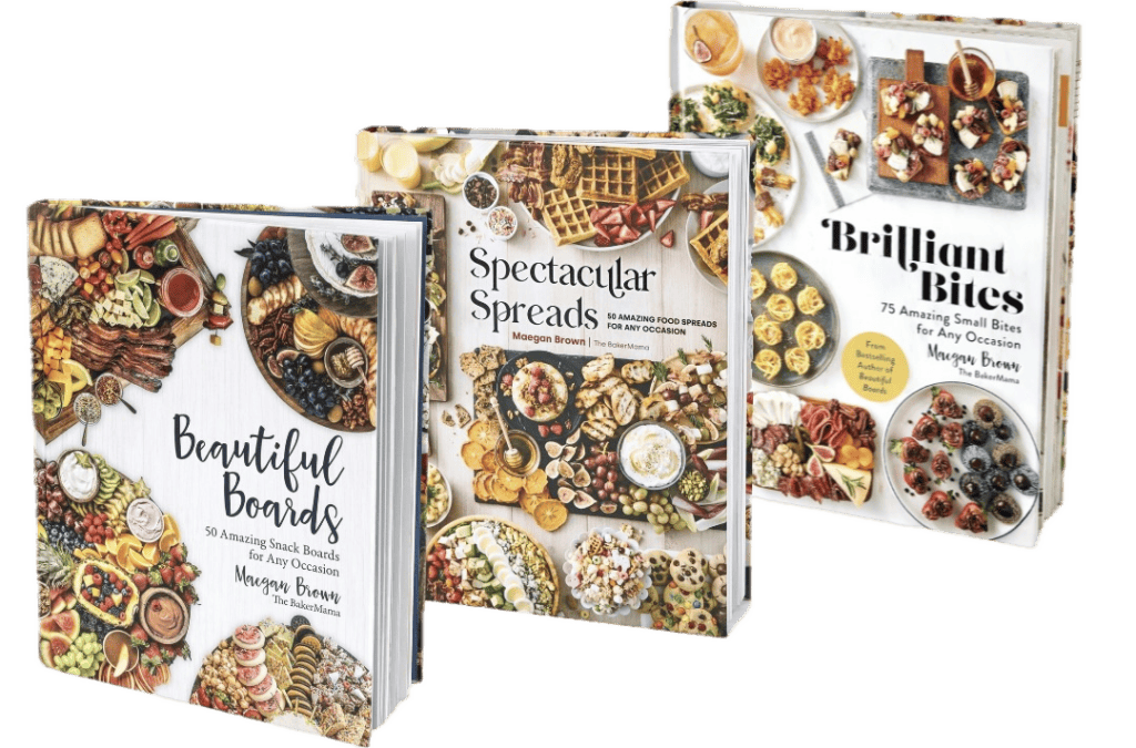 Three cookbooks in a row by author Maegan Brown. Beautiful Boards, Spectacular Spreads, Brilliant Bites