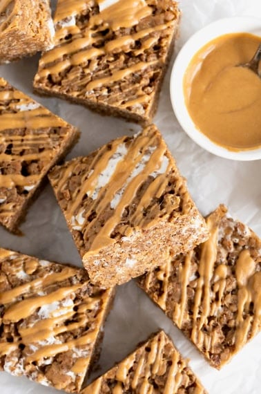 A pile of chocolate peanut butter Rice Krispies treats on a white and gray marble counter.