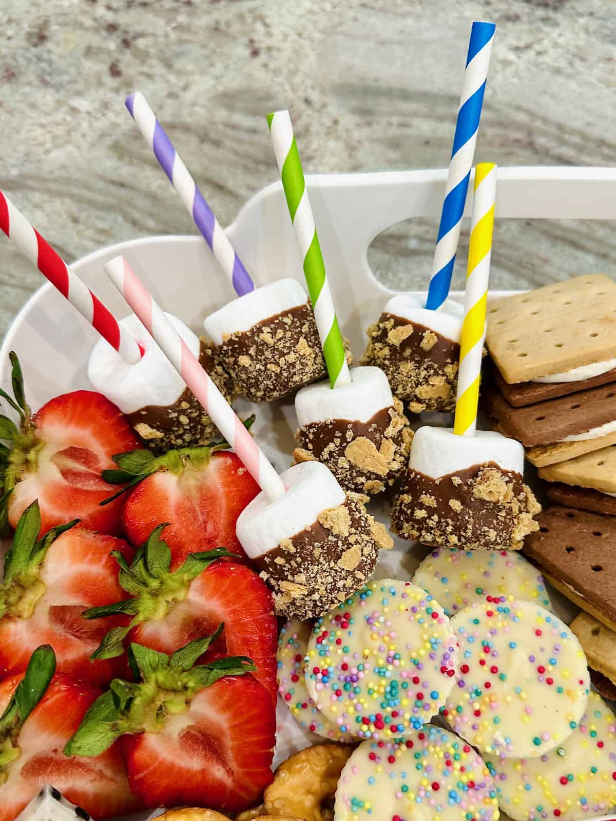 S'mores Marshmallow Pops on a S'mores tray.