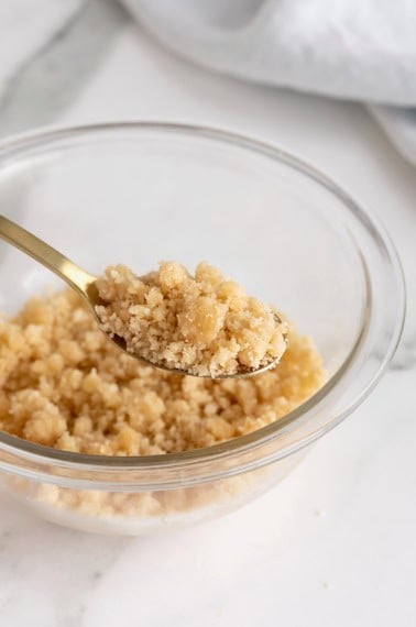 A small glass mixing bowl of streusel.