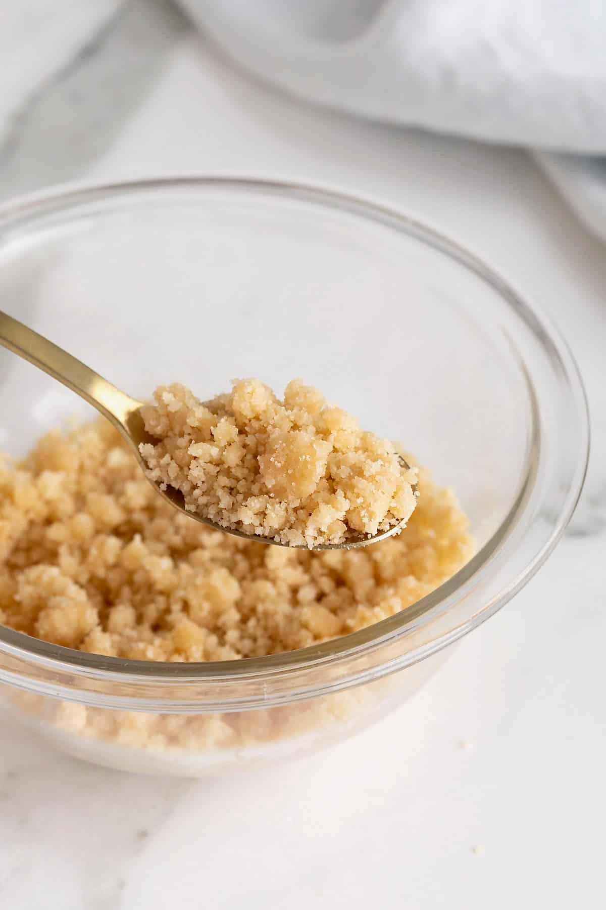 A small glass mixing bowl of streusel.