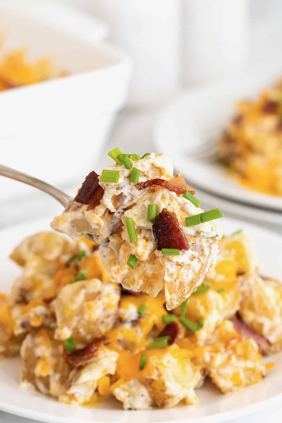 A bite of twice baked potato casserole on a fork.