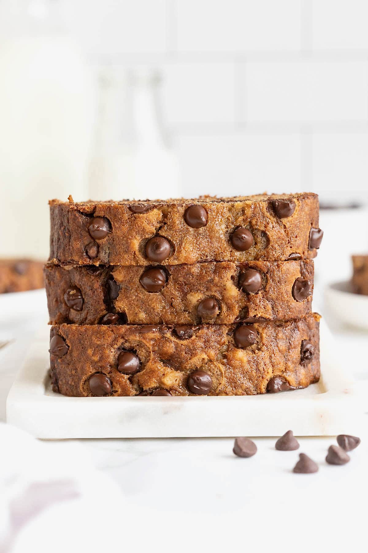 A stack of three slices of chocolate chip brown butter banana bread.