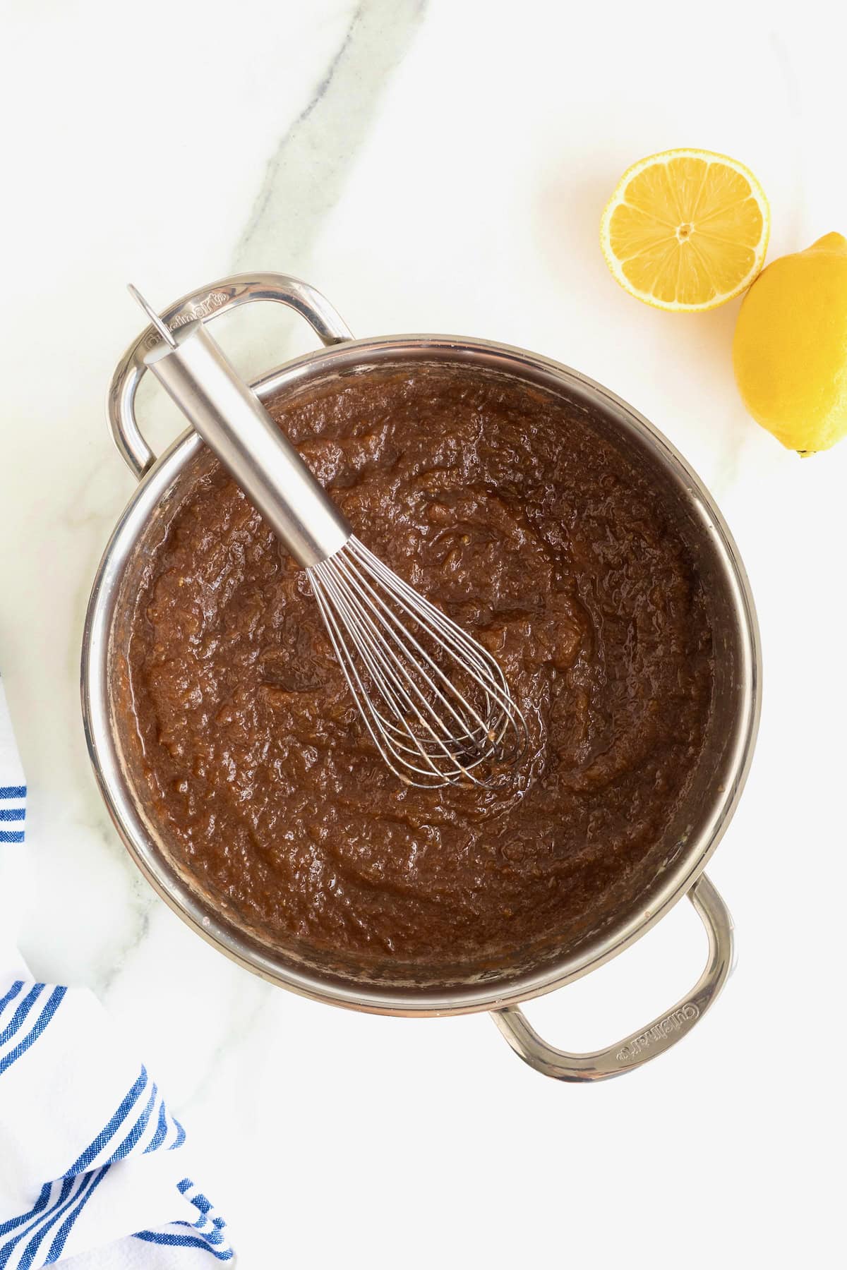A shallow stainless steel pot of homemade grape jam.