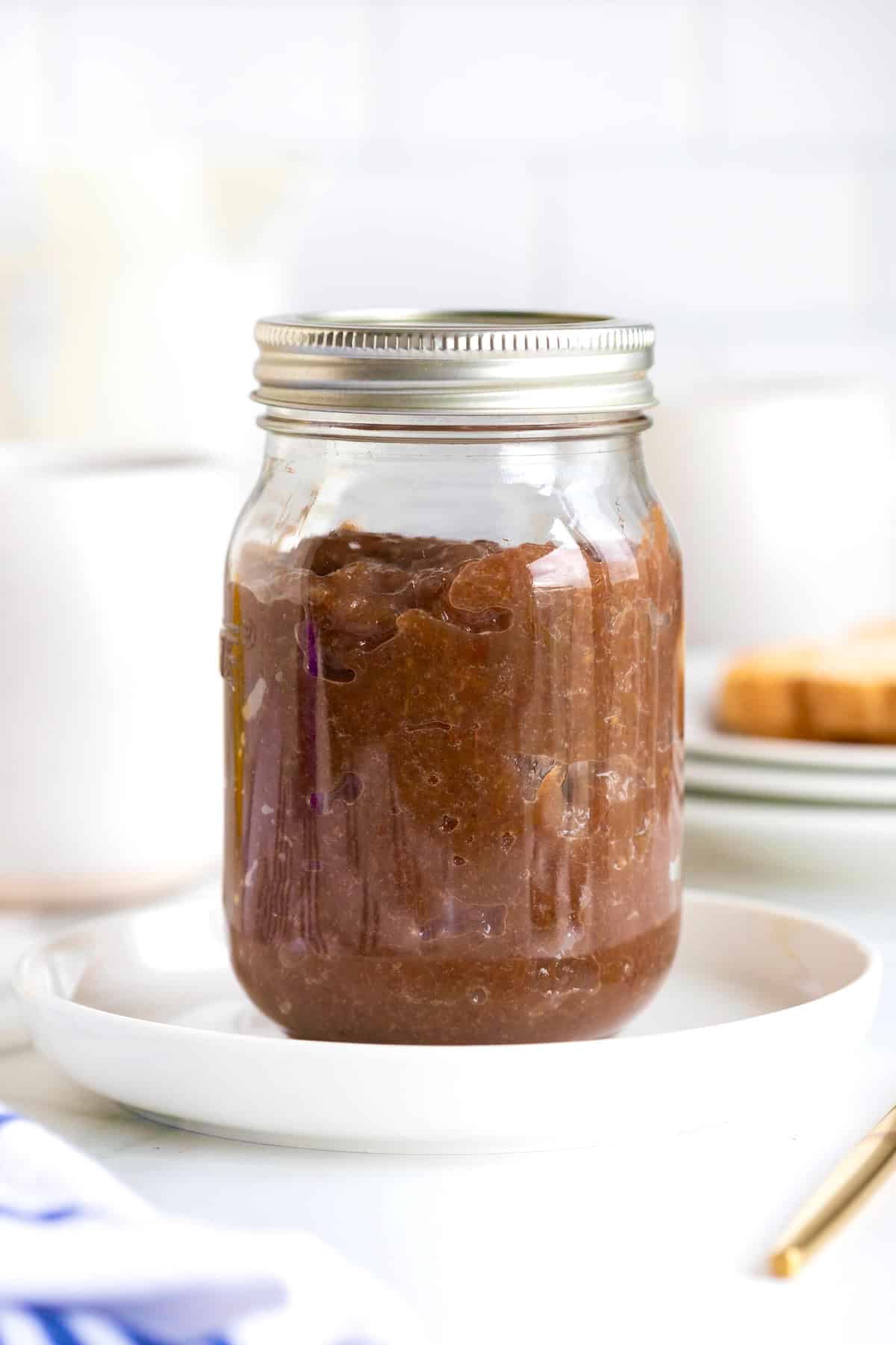 Homemade grape jam in a mason jar with the lid on.