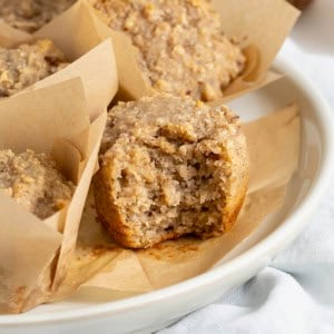 A superfood muffin with a bite out of it on a wire cooling rack.