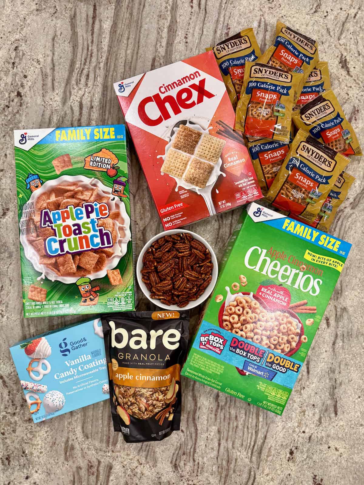 Ingredients to make Apple Pie Snack Mix on a gray and white counter.