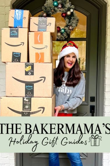 Maegan Brown wearing a Santa hat holding a tower of Amazon boxes.
