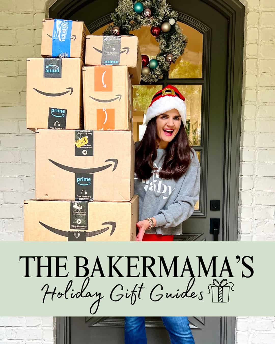 Maegan Brown wearing a Santa hat holding a tower of Amazon boxes.