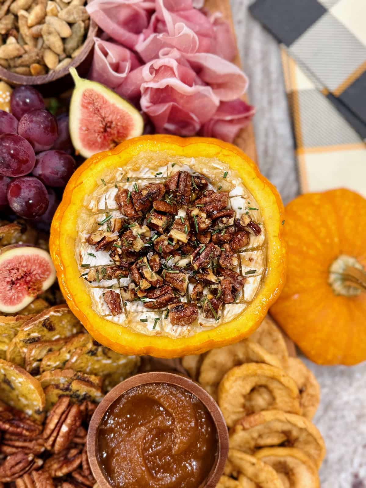 Pumpkin Baked Brie on a fall themed charcuterie board.