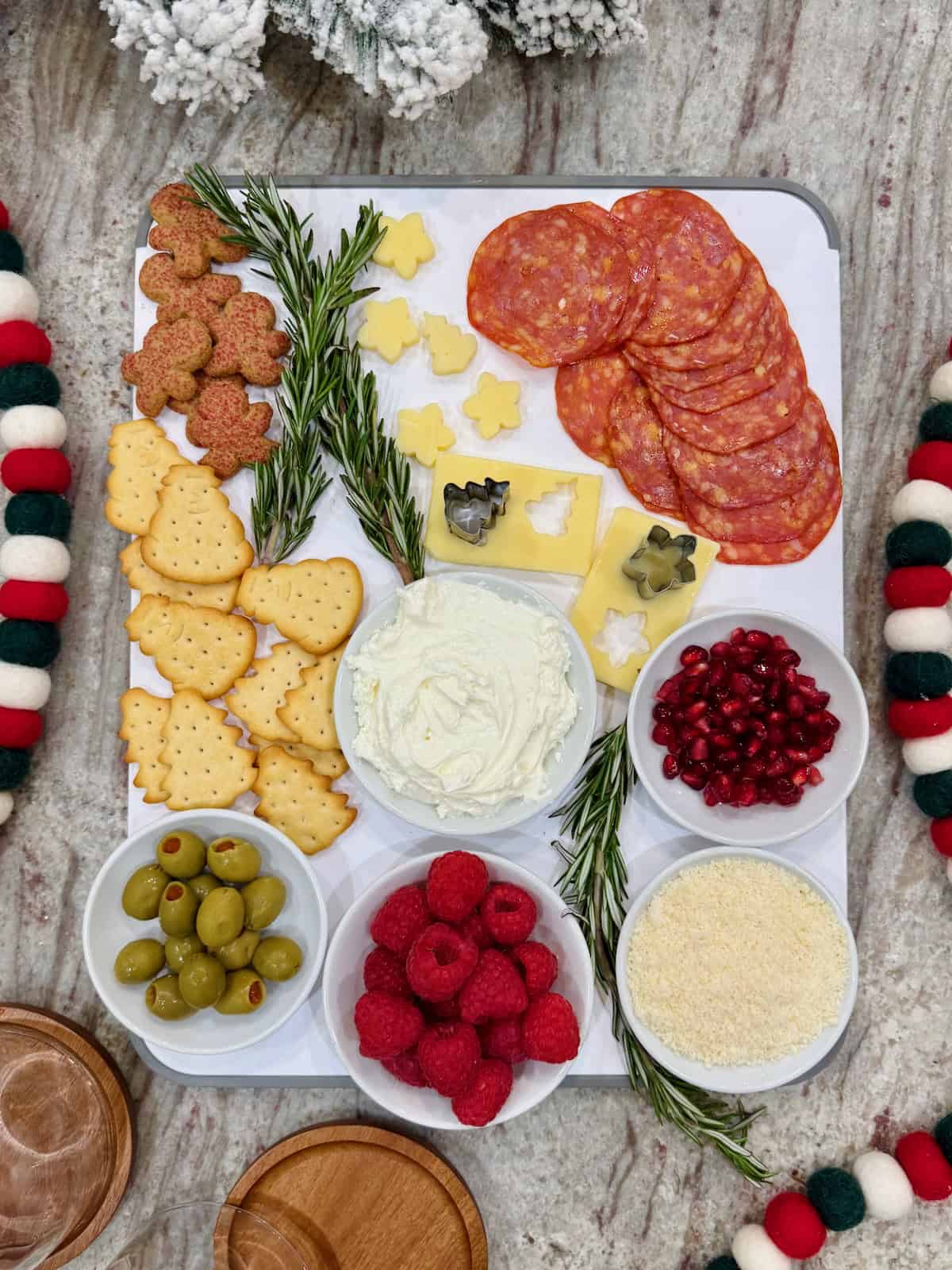 Ingredients to make Charcuterie Snow Globes on a gray marble counter.