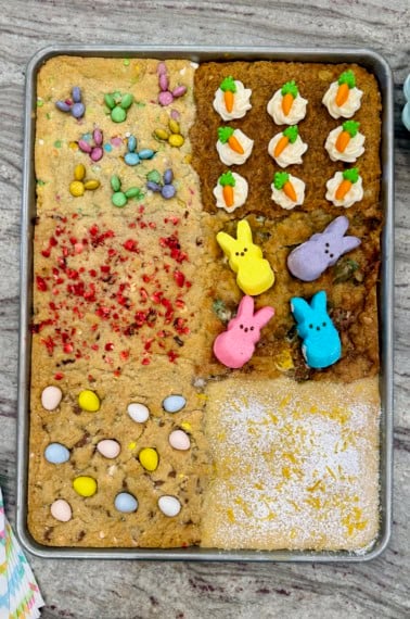 A sheet pan of six kinds of cookies decorated for Easter.