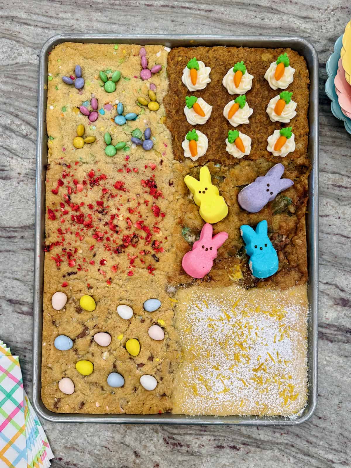 A sheet pan of six kinds of cookies decorated for Easter.