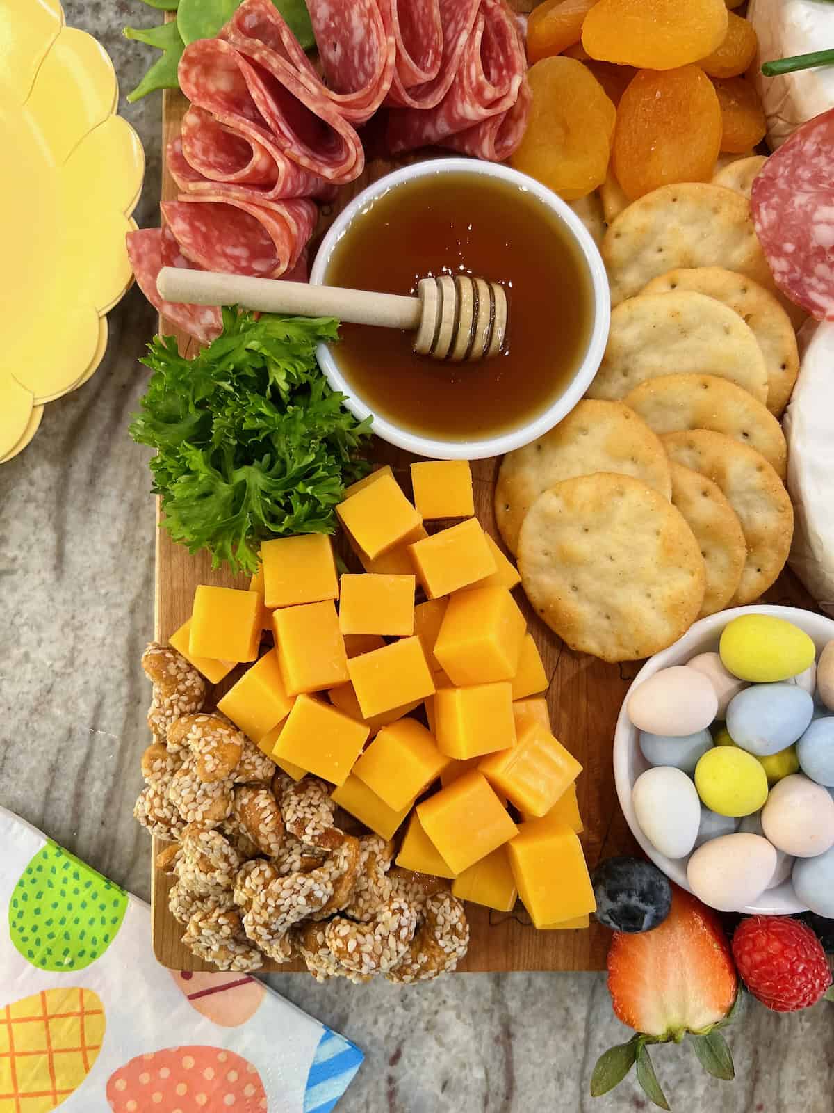 Cheddar cheese cubes arranged to look like a carrot with parsley as the carrot top.