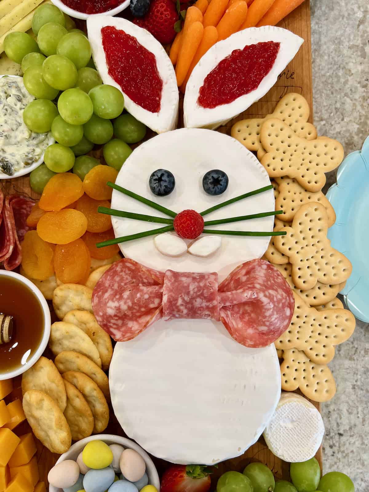 An Easter bunny made from wheels of brie, chives for the whiskers and blueberry eyes.