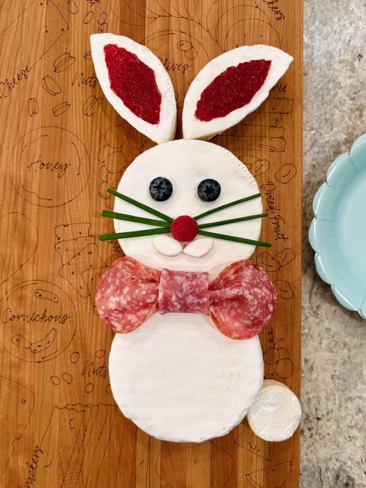 An Easter bunny made from wheels of brie, chives for the whiskers and blueberry eyes.