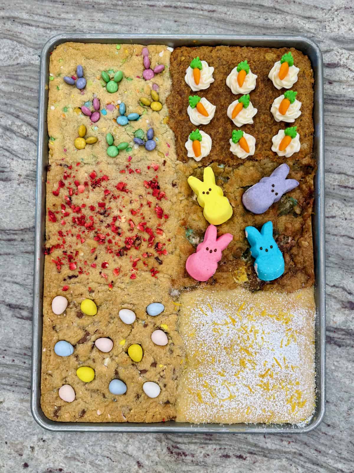 A sheet pan of six kinds of cookies decorated for Easter.