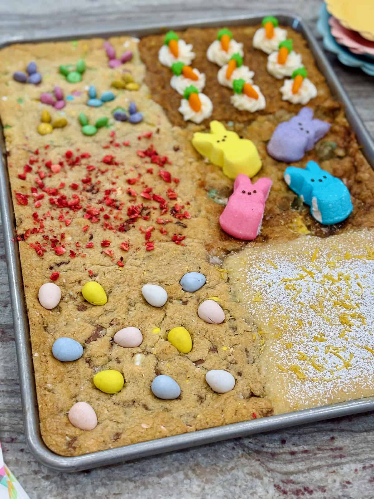 A sheet pan of six kinds of cookies decorated for Easter.