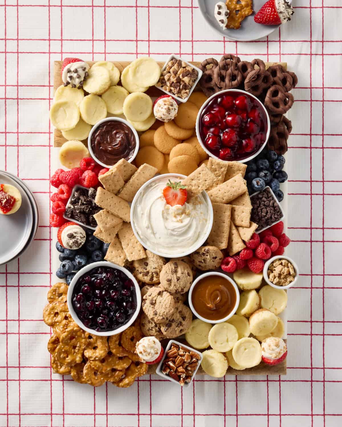 Cheesecake Board on a red and white table cloth.
