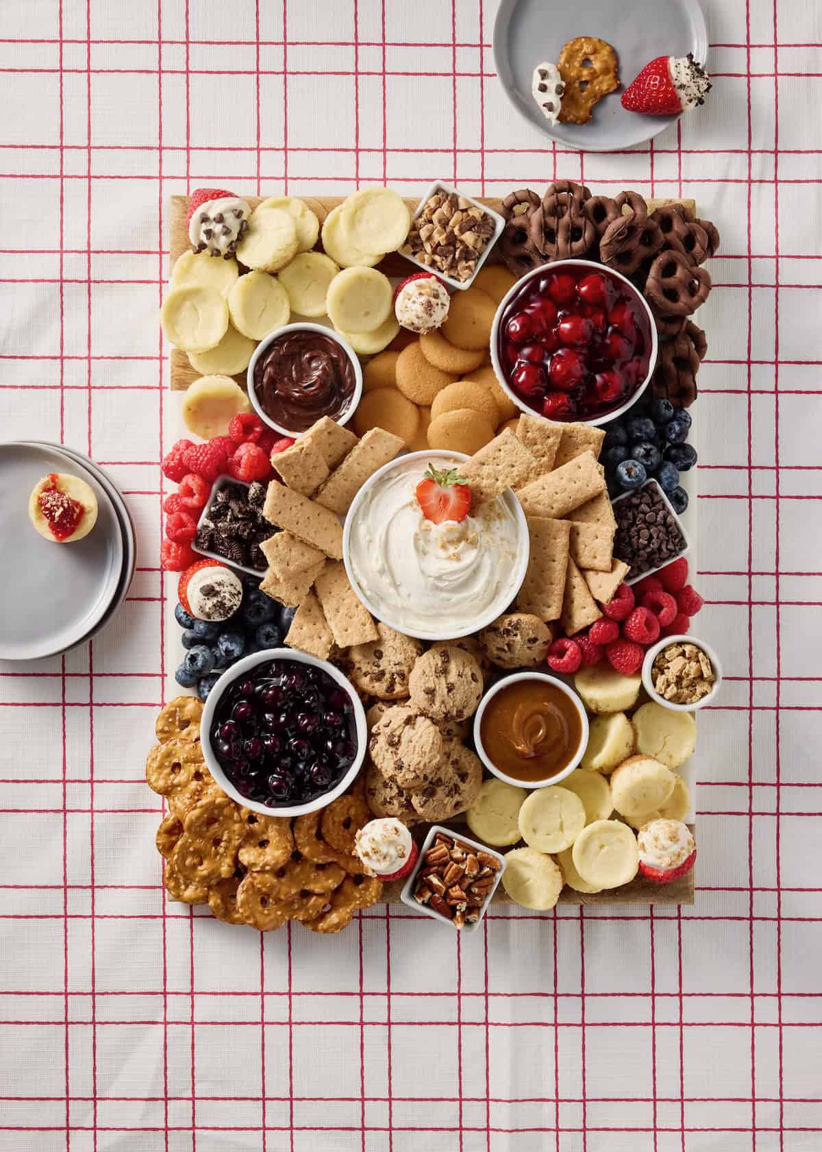 Cheesecake Board on a red and white table cloth.