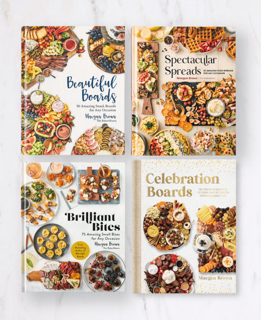 Beautiful Boards, Spectacular Spreads, Brilliant Bites and Celebration Boards cookbooks on a white marble counter.