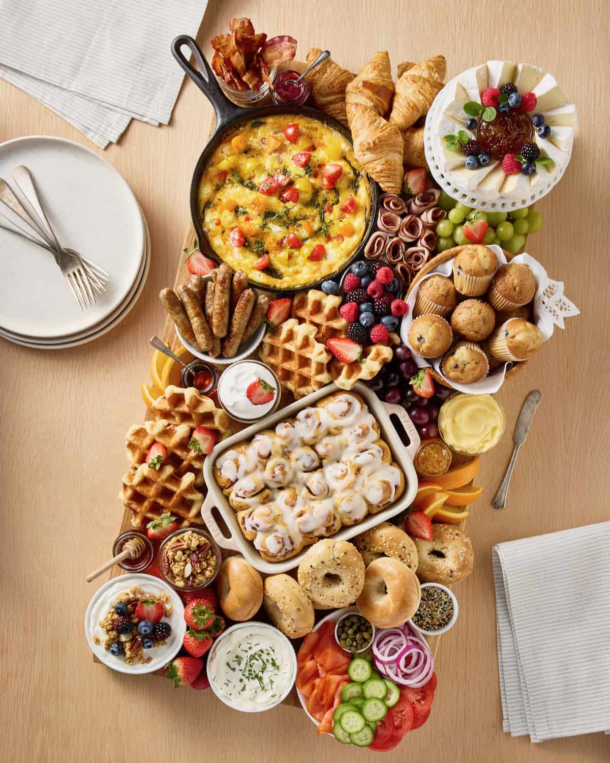 Loaded brunch board on a light colored wooden table top.