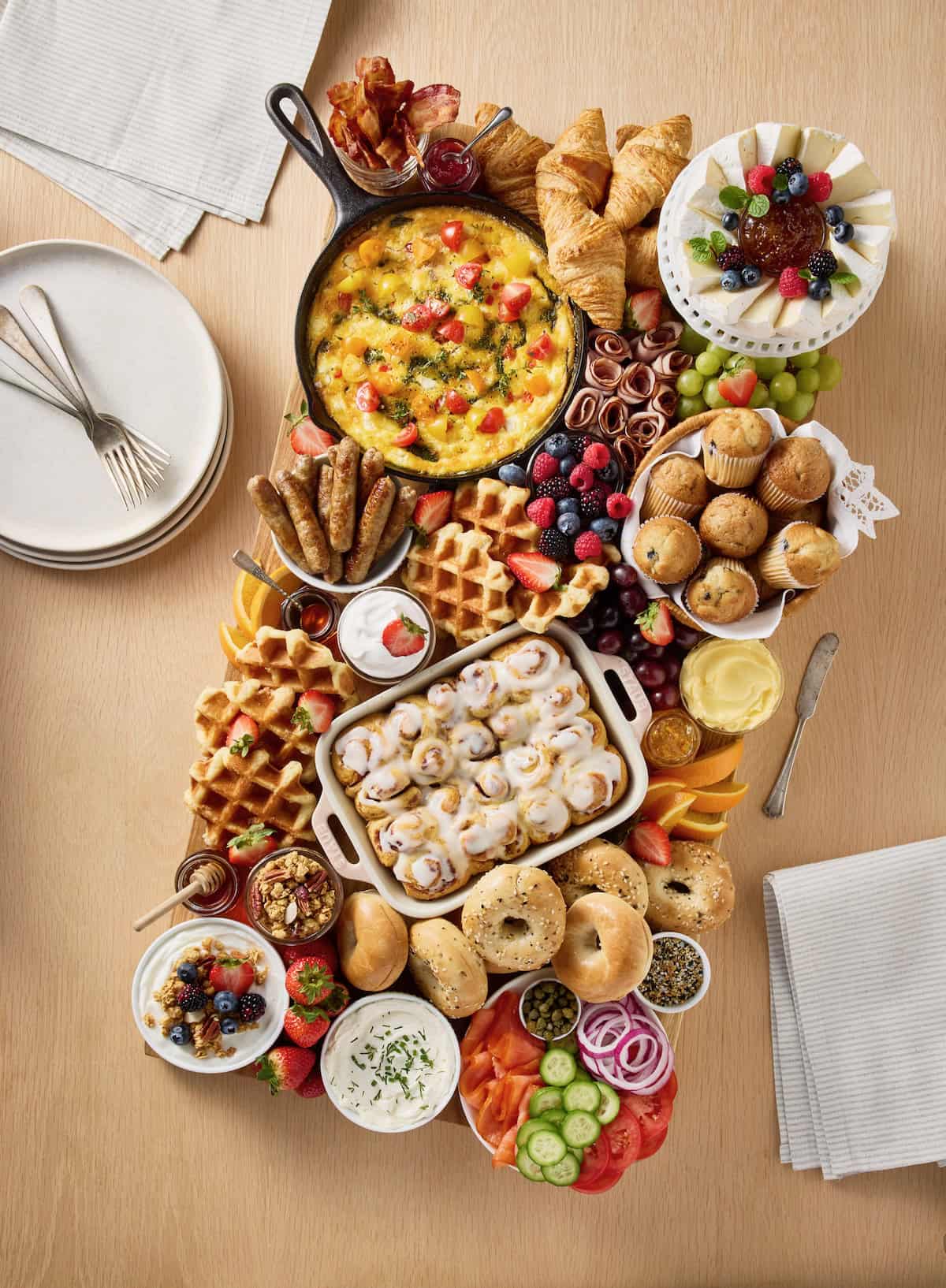 Loaded brunch board on a light colored wooden table top.