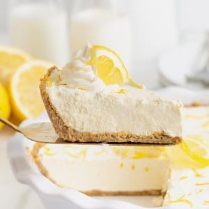 A slice of frozen lemonade pie on a pie server.