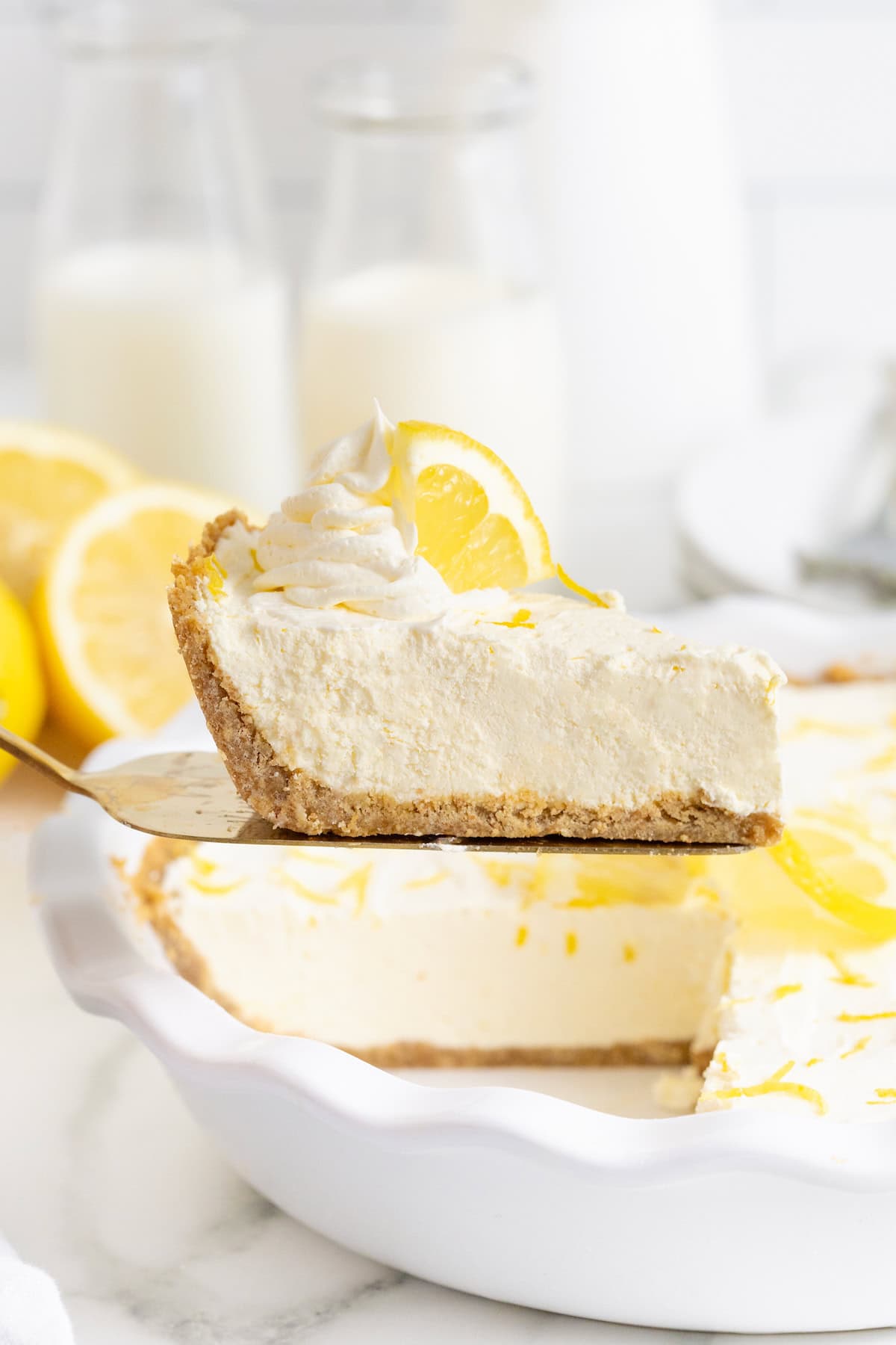 A slice of frozen lemonade pie on a pie server.