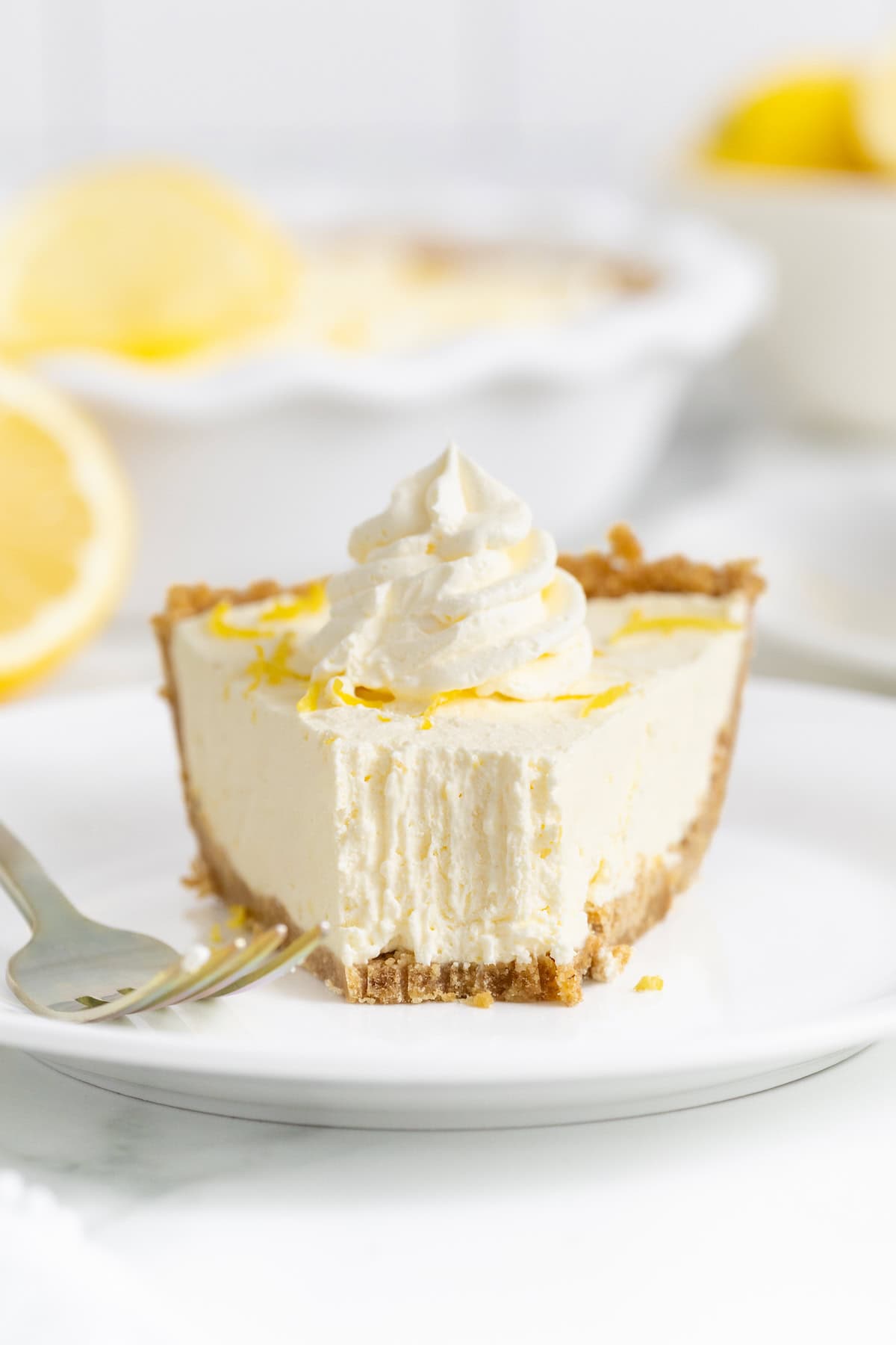 A slice of Frozen Lemonade Pie on a small white dessert plate.