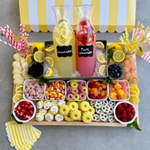 A food board with lemonade options and snacks.
