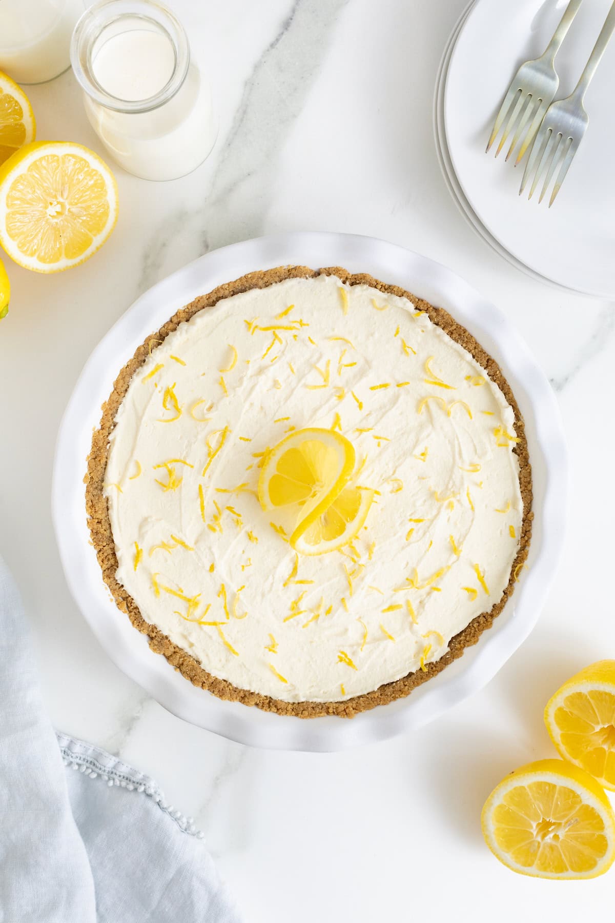 A finished frozen lemonade pie garnish with lemon slices and lemon zest.