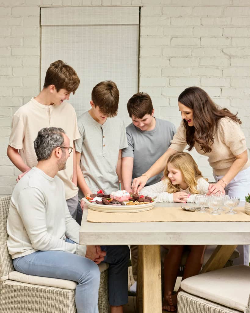 The Brown family eating from a brownie ice cream sundae dessert board.