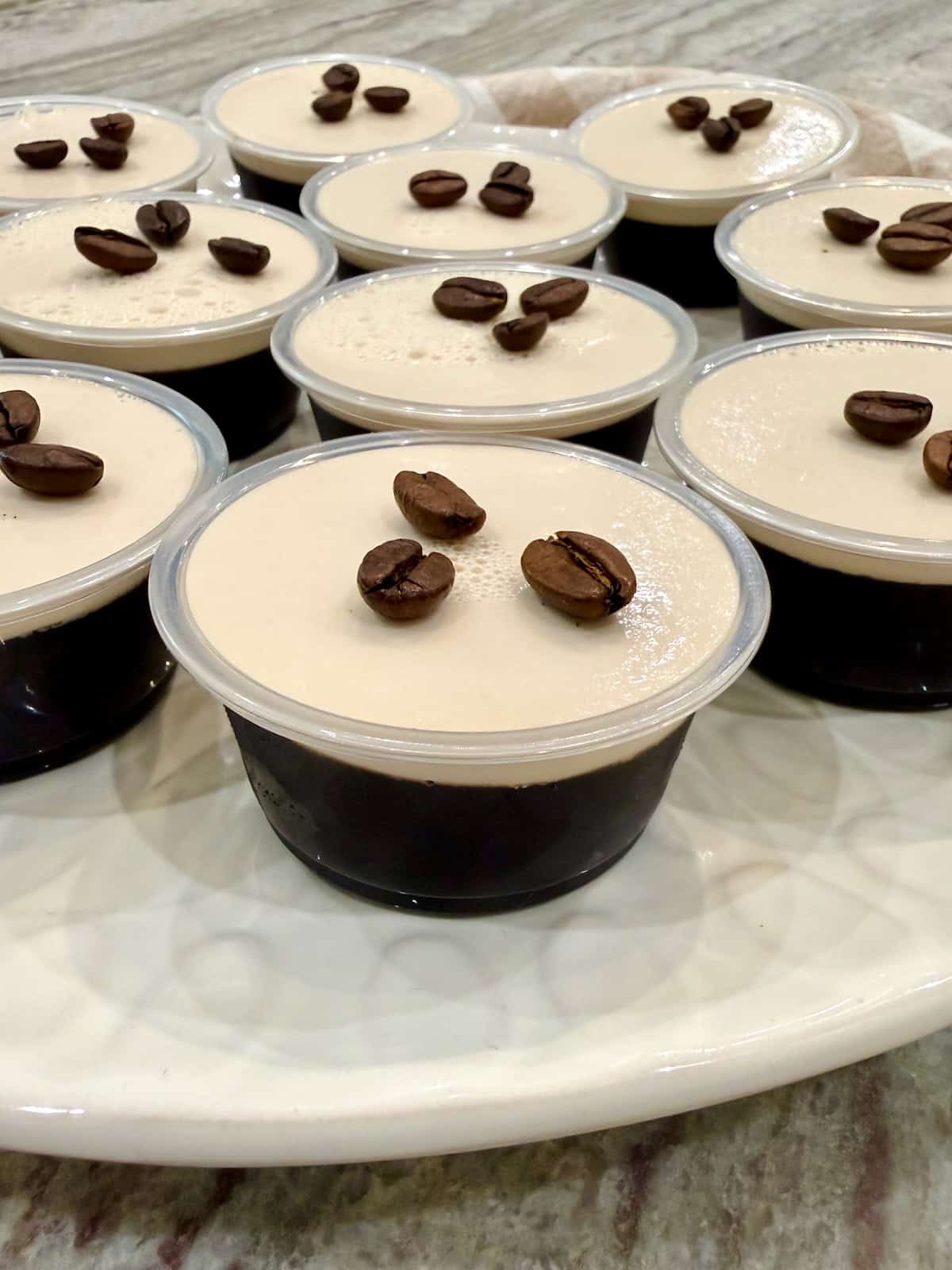 A marble tray filled with espresso martini Jell-O shots.
