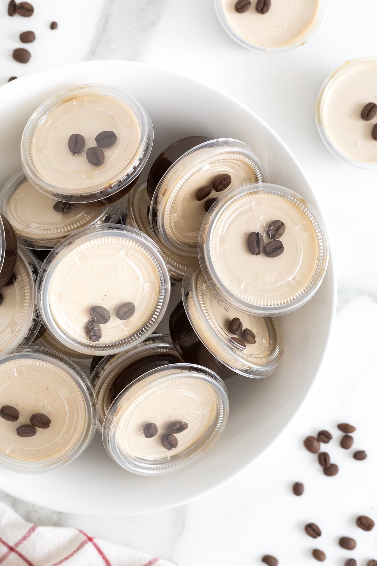 A white serving platter filled with espresso martini jello shots.
