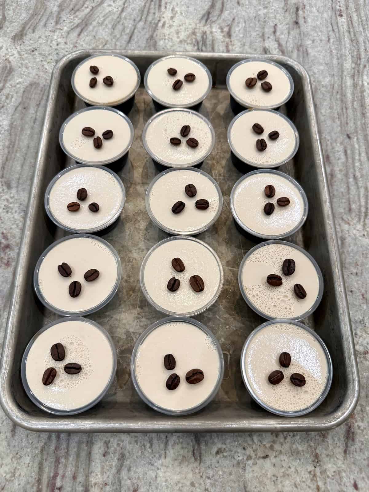 A baking sheet filled with espresso martini Jell-O shots.