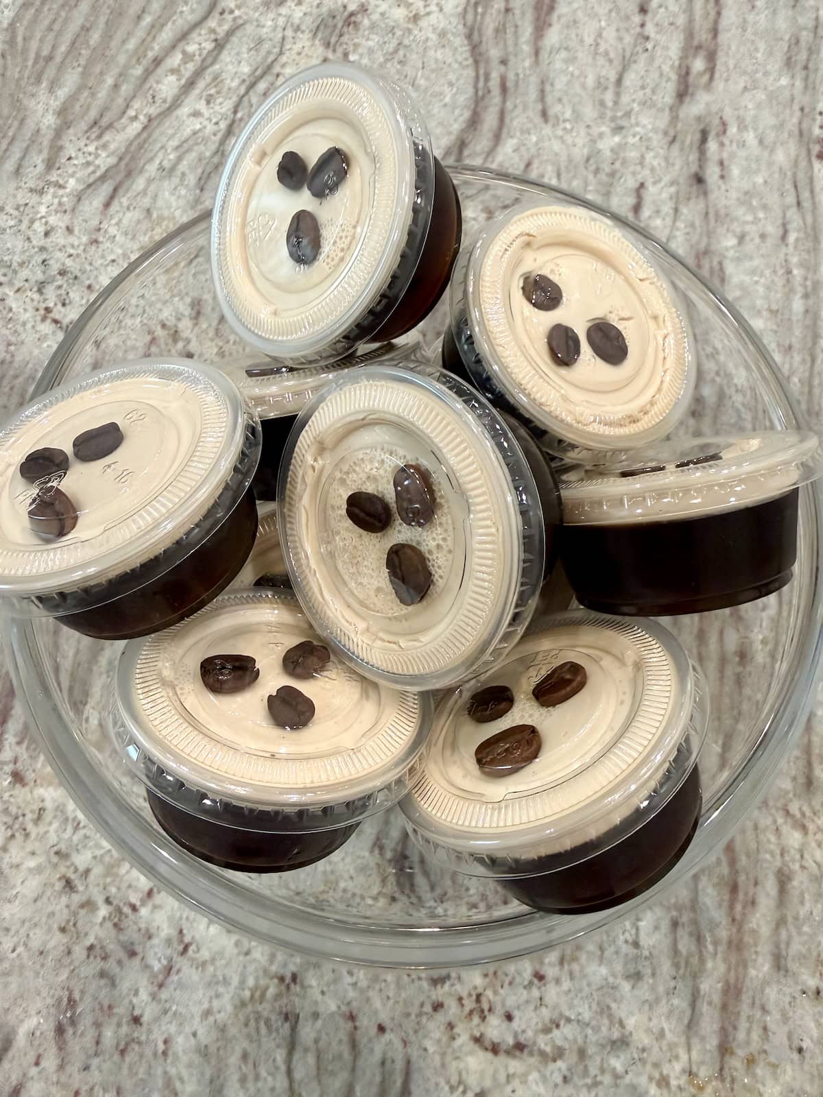 A clear glass bowl filled with espresso martini Jell-O shots.